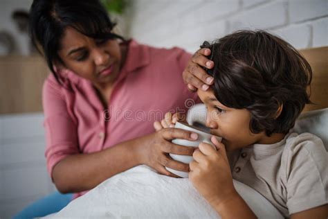 Mother Taking Care Of Her Ill Son At Home Stock Image Image Of Motherhood Love