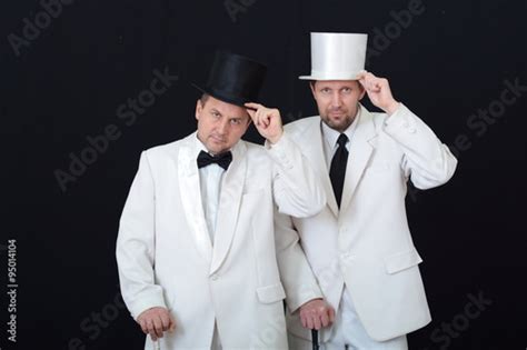 Two Men In White Suits And Hats Holding Canes Stock Photo And Royalty