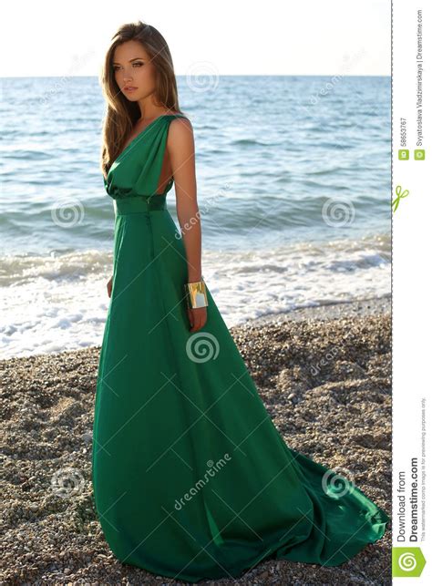 Beautiful Girl With Blond Hair Wears Luxurious Green Dress