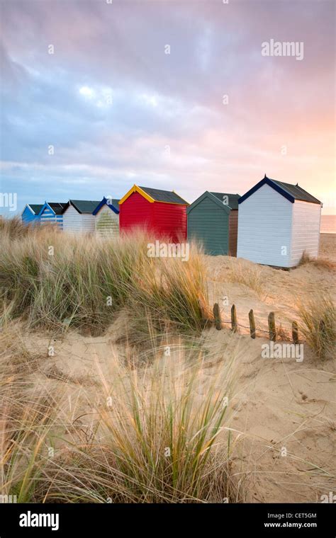 Dawn Over Sand Dunes And Colourful Beach Huts Along The Seafront At