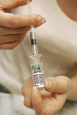 In multiple sclerosis, the immune system attacks and damages the protective coating that surrounds the nerves. Multiple sclerosis treatment - Stock Image - M727/0039 ...