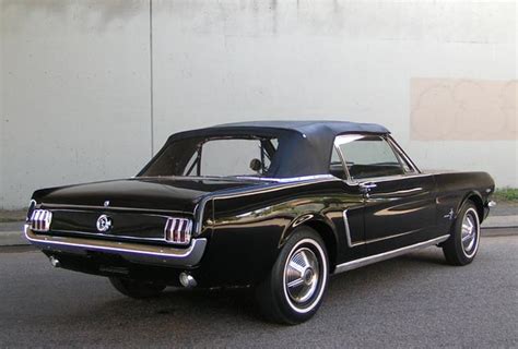 With an opening hood to reveal a modified v8 engine. 65 MUSTANG CONVERTIBLE