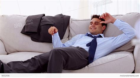 Smiling Businessman Lying On Sofa Stock Video Footage