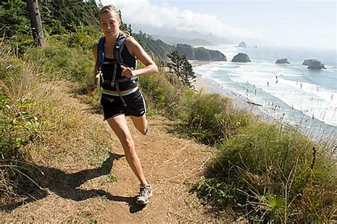 Young Woman Trail Running In Ecola State Park Cannon Beach Or