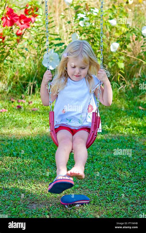 Little Blond Girl On Swing With Flip Flops Stock Photo Alamy