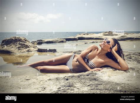 Brunette Woman Laying On The Beach Stock Photo Alamy