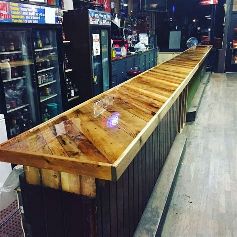 The best way to apply varnish, which will make it possible to achive professional result is to use bristle brush. Bar top made from pallet boards and covered with epoxy ...
