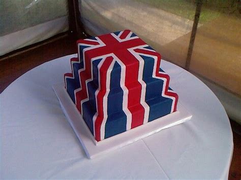 A Red White And Blue Cake Sitting On Top Of A Table Next To A Window
