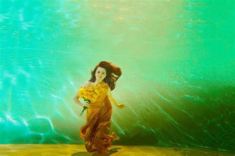 Girl In A Beautiful Dress Under Blue Water Female Model Posing Under Water In Swimming Pool