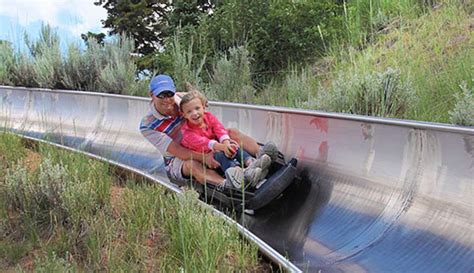 A Father And Daughter Ride The Alpine Slide At Utah Olympic Park