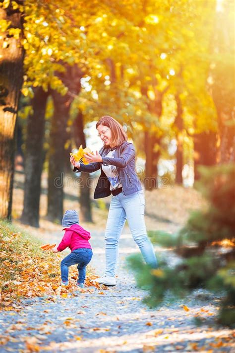 2 Years Old Toddler Have Fun Outdoor In Autumn Yellow Park Stock Image