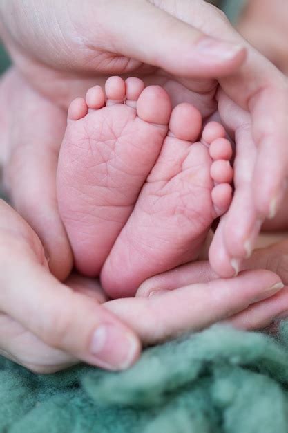 Premium Photo Newborn Baby Feet In Hand