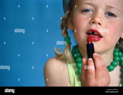Little Girl Putting On Lipstick Close Up Stock Photo Alamy