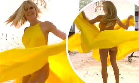Heidi Klum Flashes A Glimpse Of Her Bottom As She Twirls In Yellow Gown