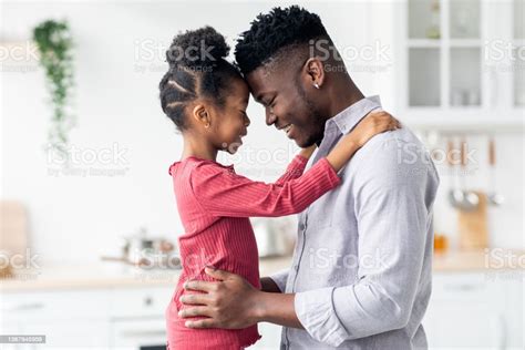 Emotional Photo Of Loving Black Father And Daughter Cuddling Stok