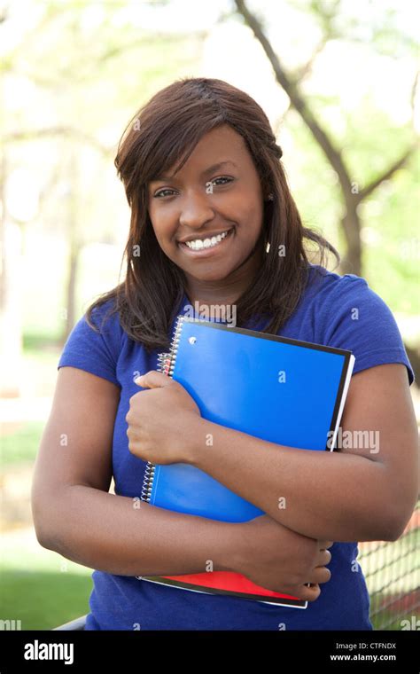 A Pretty Female African American College Or University Student Holding