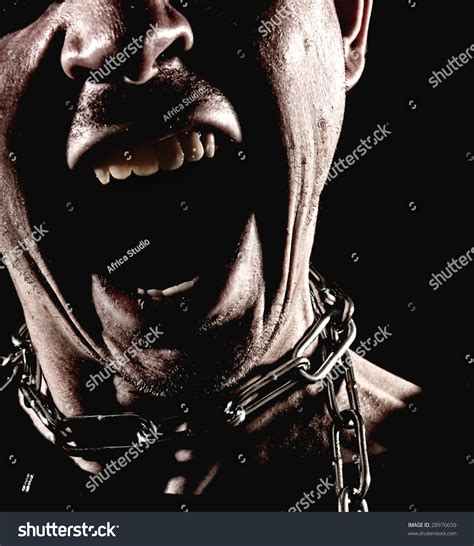 Closeup Of A Man Wearing A Chain Around His Neck With His Mouth Wide