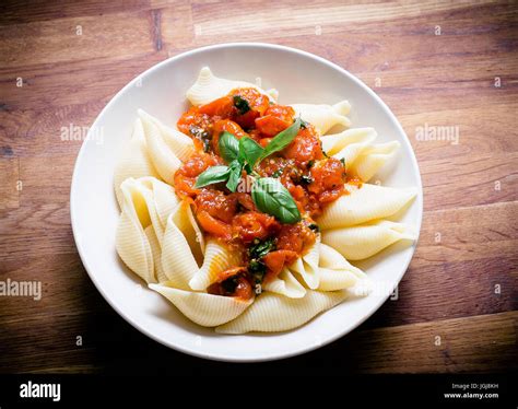 Pasta Shells With A Tomato Sauce And Basil Stock Photo Alamy