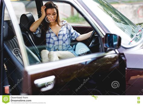 Young Brunette Woman Sits In A Car Looking Down Stock Image Image Of