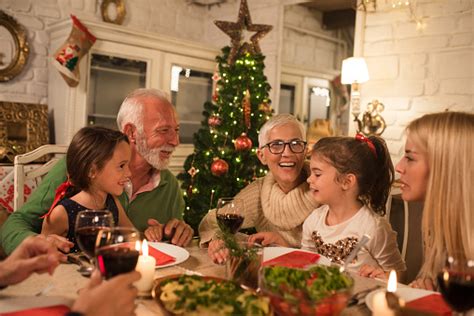 There are no holidays without delicious meals typical of this or that country. Happy Family At Christmas Dinner Party Stock Photo - Download Image Now - iStock