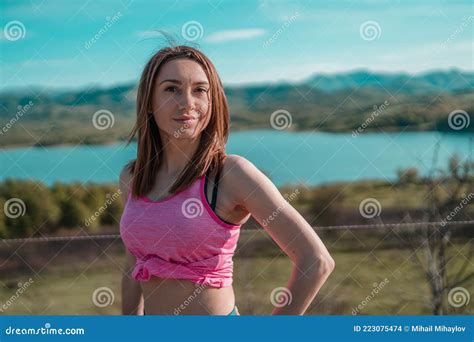 Beautiful Sporty Fit Female Jogger With Pink Top Posing Outdoors In The