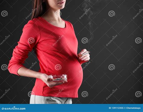 Pregnant Woman Smoking Cigarette On Black Background Closeup Stock