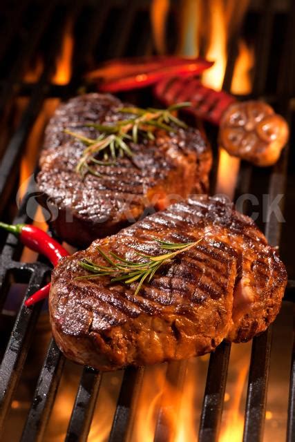 The flavor is just wonderful. Beef Steaks On The Grill | Stock Photos