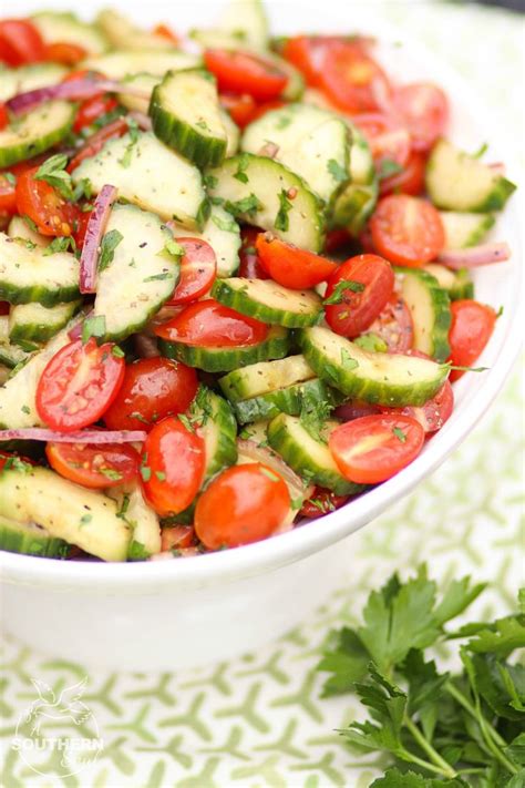 A White Bowl Filled With Cucumber And Tomatoes