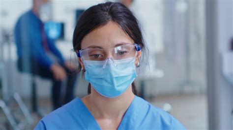 Close Up Of Tired Nurse With Protection Mask For Coronavirus Outbreak