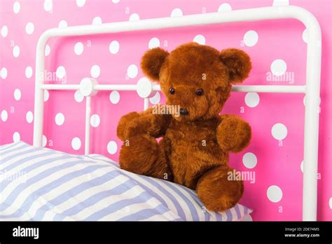 Girls Bedroom With Pink Wall Paper And Stuffed Bear Stock Photo Alamy
