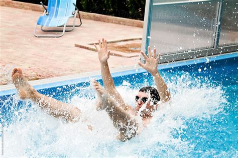 Man Splashing In A Pool Del Colaborador De Stocksy Emoke Szabo