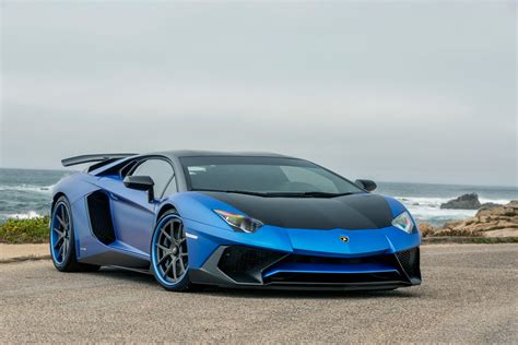 Blue And Black Lamborghini Gallardo Parked On Gray Sand Near Ocean
