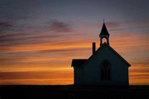 Scenic Country Church Silhouetted Against Colorful Orange Sunset