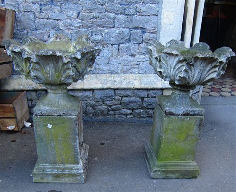 A Pair Of Weathered Composition Stone Garden Urns With Acanthus Leaf