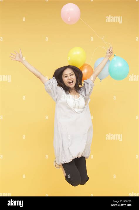 Young Woman Holding Balloons Stock Photo Alamy