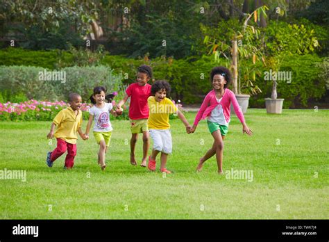 Children Playing In A Lawn Stock Photo Alamy