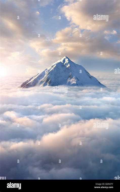 Snow Covered Mountaintop Above Clouds Stock Photo Alamy