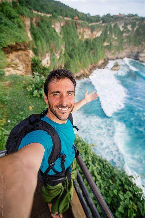 Middle Aged Man Takes Selfie Against View Of Cliffs And Sea In Tropical Island Del Colaborador