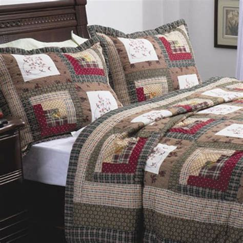 A Bed With A Quilted Comforter And Pillows