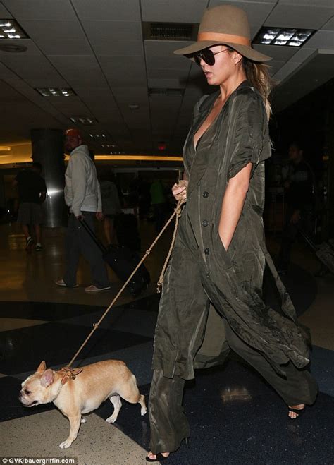 Pregnant Chrissy Teigen Shows Cleavage As She Jets Into La With Her Dog