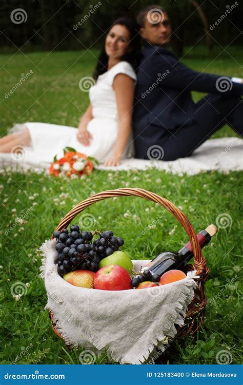 Basket With Products For A Picnic On The Clearing In The Distance