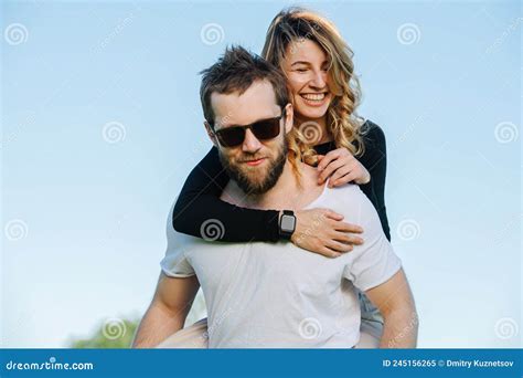 Wife Riding On Husband They Are Enjoying Their Summer Vacation In Countryside Stock Image