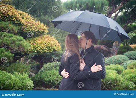 Young Romantic Couple With Umbrella Kissing In The Rain Stock Image Image Of Rain Feeling