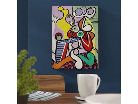 A Painting Hanging On The Wall Next To A Table With A Cup And Saucer