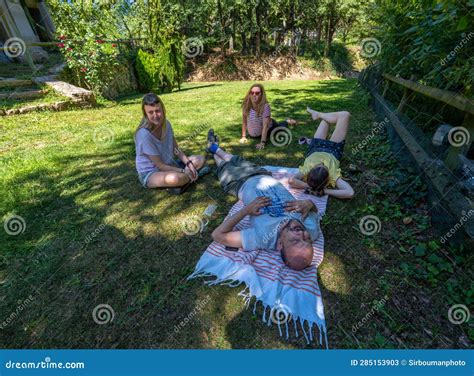group of male and female friends resting napping stretching and exercising on the ground of