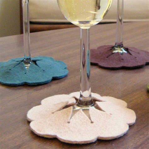 Three Wine Glasses Sitting On Top Of A Wooden Table