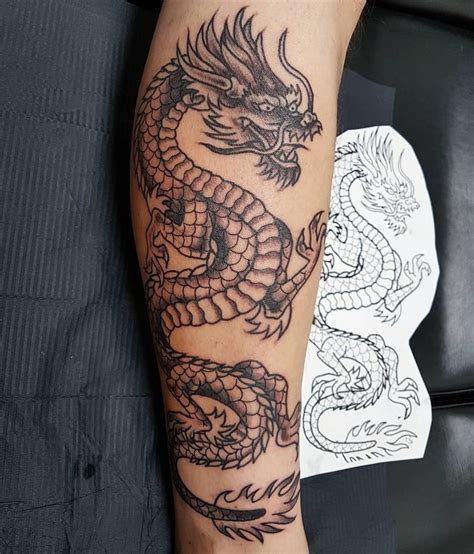 A Man With A Dragon Tattoo On His Arm