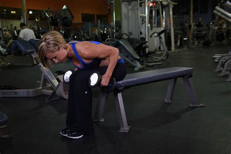 seated bent over two arm dumbbell triceps extension exercise guide and video