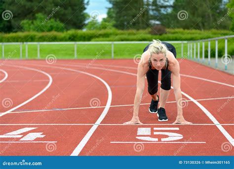 Athletic Woman In The Starter Position On A Track Stock Photo Image