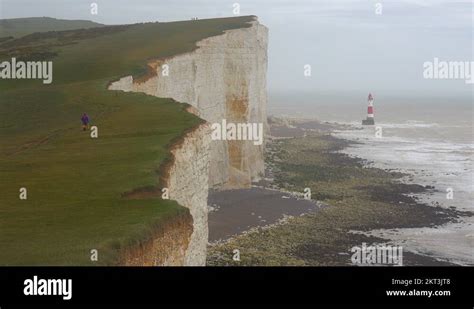 A Lighthouse Along The White Cliffs Of Dover Near Beachy Head In